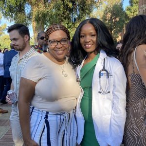 Hellen Jumo '20 earlier this fall during the white coat ceremony marking her start at the David Geffen School of Medicine at University of California at Los Angeles. With her is Yolanda Caldwell, director of the BOLD Women's Leadership Institute at 91̽, and a mentor, who traveled across the country to celebrate the occasion with Jumo.